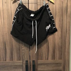 Pink brand black shorts with logo down the side